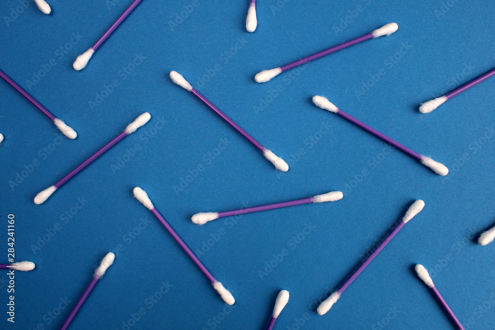 White cotton paper sticks on a blue background White cotton paper sticks on a blue background
