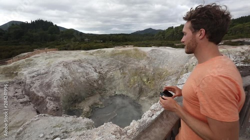 New Zealand travel tourist taking phone picture of famous attraction, Waiotapu. Active geothermal area, Okataina Volcanic Centre, Reporoa, in Taupo Volcanic Zone, Rotorua, north island. photo