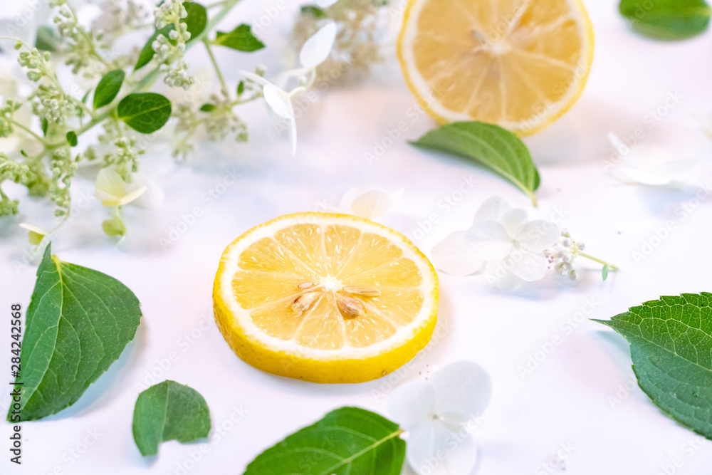 Creative layout made of lemon and leaves. Flat lay. Food concept. Lemon on white background