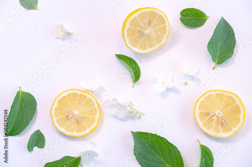 Creative layout made of lemon and leaves. Flat lay. Food concept. Lemon on white background