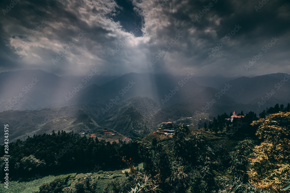 Sapa in Vietnam with paddy fields, terraces, valleys and Fansipan mountain during dramatic stormy weather in asia.