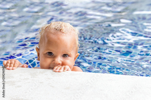 Cute baby swims in a swimming pool in summer © Maria Mikhaylichenko