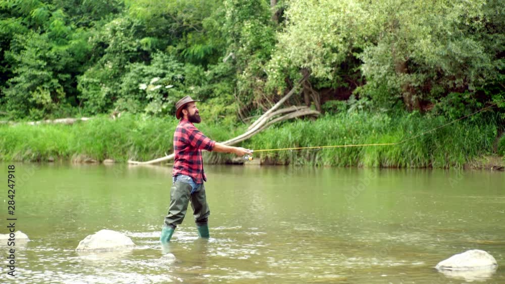 Summer holidays and people concept. Man fishing and relaxing while enjoying hobby. A fisherman with fishing rod on the river. Fisherman and trout. Summer holidays and people concept. Man fishing and relaxing while enjoying hobby. A fisherman with fishing rod on the river. Fisherman and trout.