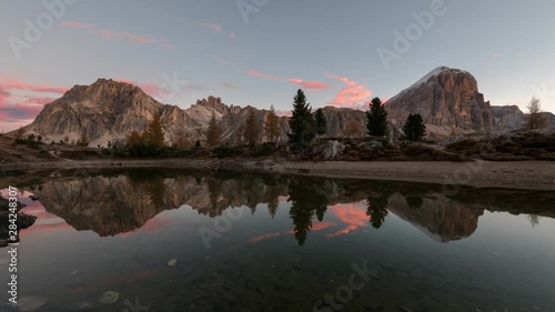 Lake Limedes is a small alpine lake above the mountain pass Falzarego in Italian Dolomites. This is a 4k Time-lapse from the beautiful autumn sunrise. photo