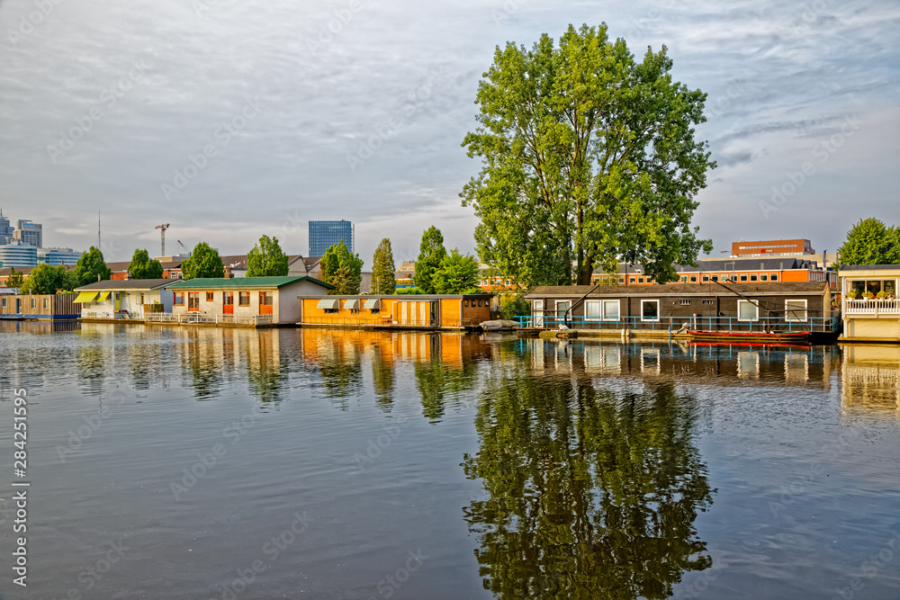 Amsterdam floating houses in river Amstel channel