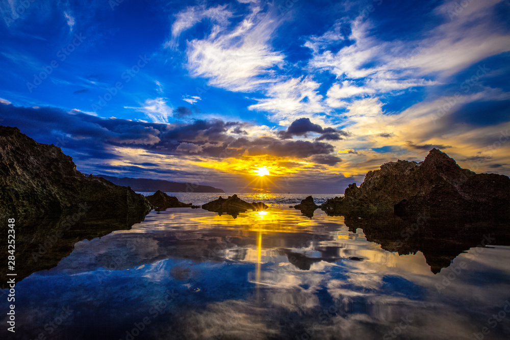 Amazing North Shore Oahu sunset reflected in a tide pool