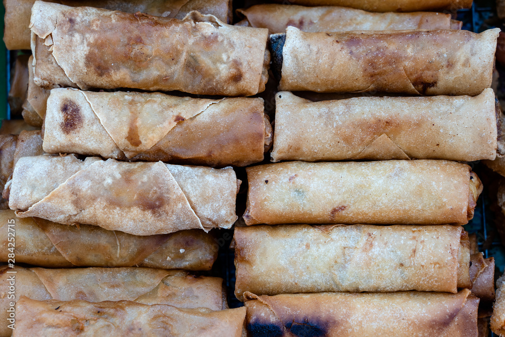 Fried flour roll for sell in street food market, Thailand, closeup wrapped pancakes Fried flour roll for sell in street food market, Thailand, closeup wrapped pancakes