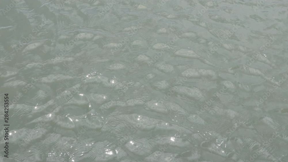 top view of ocean background and moderate wave with shiny sun light reflection, close up. top view of ocean background and moderate wave with shiny sun light reflection, close up.