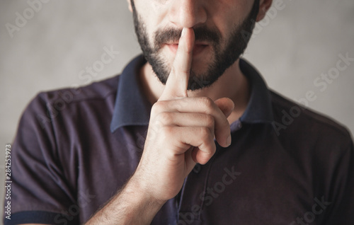 Man making silence gesture, shhh.