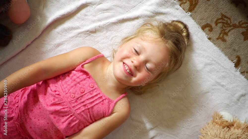 a little girl throws a plush toy a little girl throws a plush toy