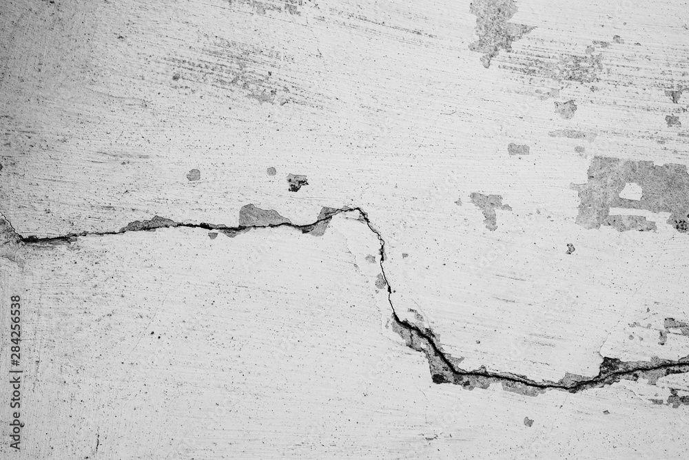 Texture of a concrete wall with cracks and scratches which can be used as a background Texture of a concrete wall with cracks and scratches which can be used as a background
