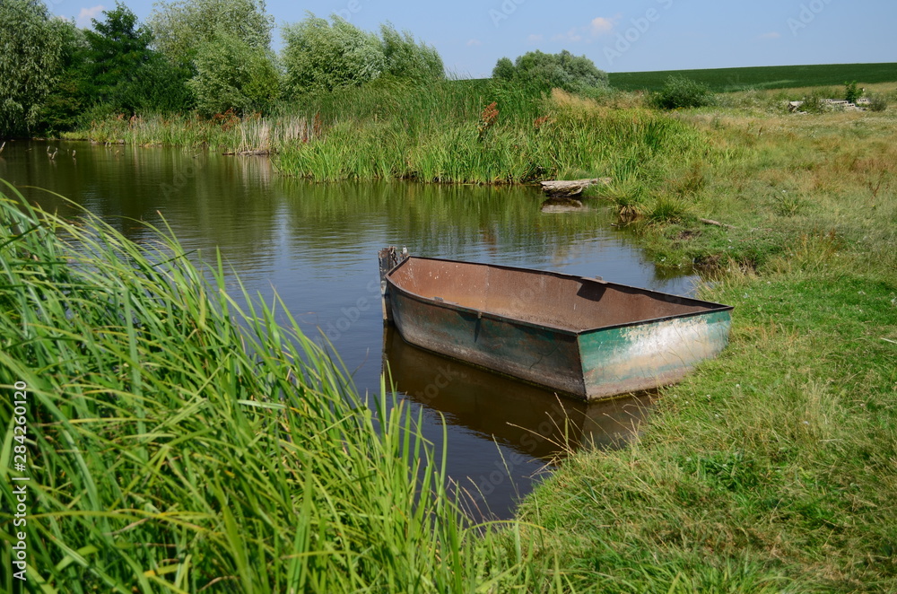 fishing boat in a calm lake water at morning fishing boat in a calm lake water at morning