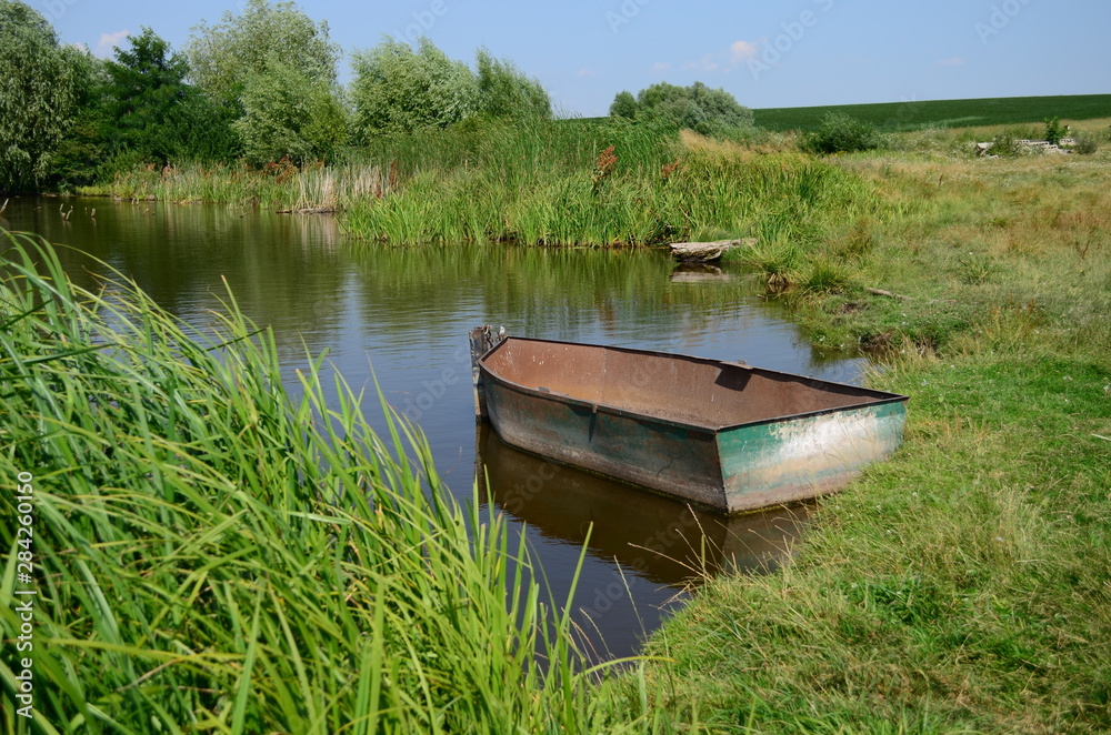 fishing boat in a calm lake water at morning