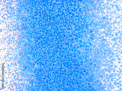 Background of blue texture of blue granules.Ice crystal on a light background.Blue tile mosaic.Interior Design.Interior.