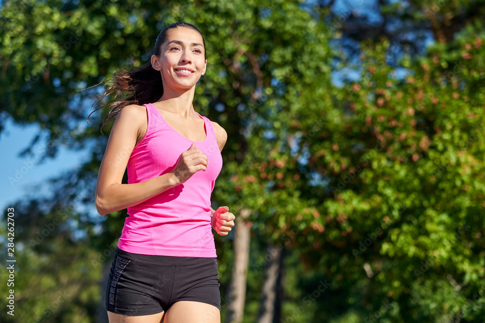 Running woman. Female Runner Jogging during Outdoor Workout in a Park. Beautiful fit Girl. Fitness model outdoors. Weight Loss Running woman. Female Runner Jogging during Outdoor Workout in a Park. Beautiful fit Girl. Fitness model outdoors. Weight Loss