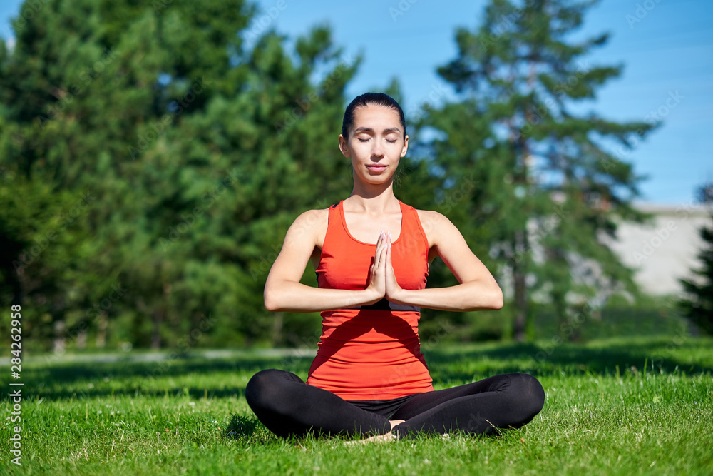 Yoga. Young woman practicing yoga meditation in nature a park. lotus posture. Health lifestyle concept Yoga. Young woman practicing yoga meditation in nature a park. lotus posture. Health lifestyle concept