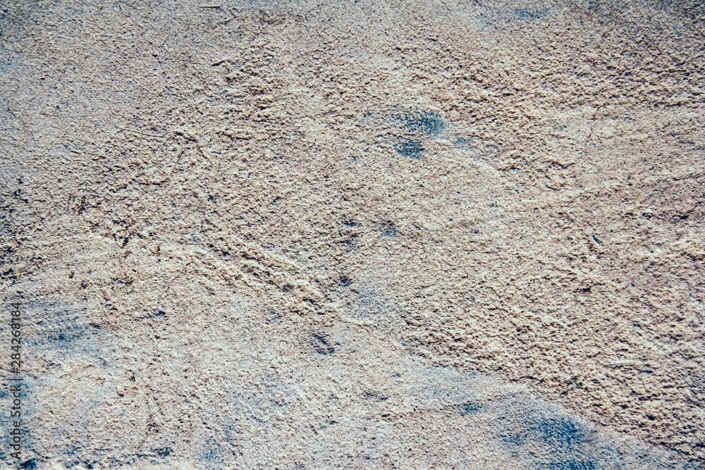 Structure of concrete surface with admixtures of stones as background image. Rough building material of gray color Structure of concrete surface with admixtures of stones as background image. Rough building material of gray color