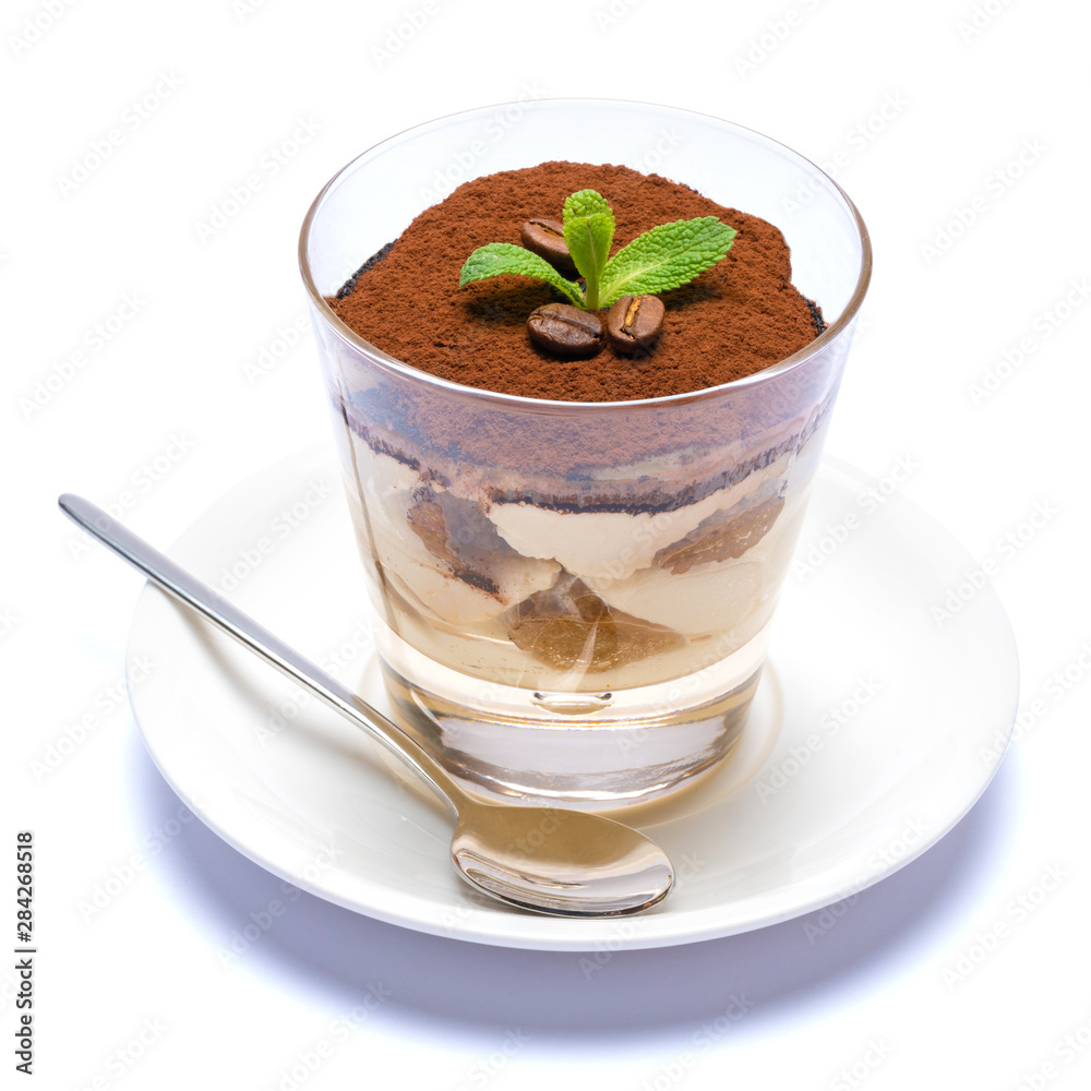 Classic tiramisu dessert in a glass cup on the plate on white background with clipping path Classic tiramisu dessert in a glass cup on the plate on white background with clipping path