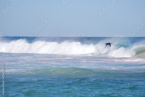Surfers on clear cold winter morning at Trigg Beach Western Australia photo