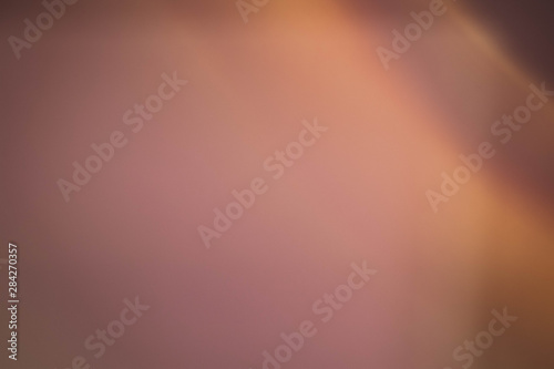 Smeared light glow. Copper colored abstract art background. Blur lens flare design.