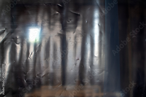 Plastic curtain with lights and window in the background.