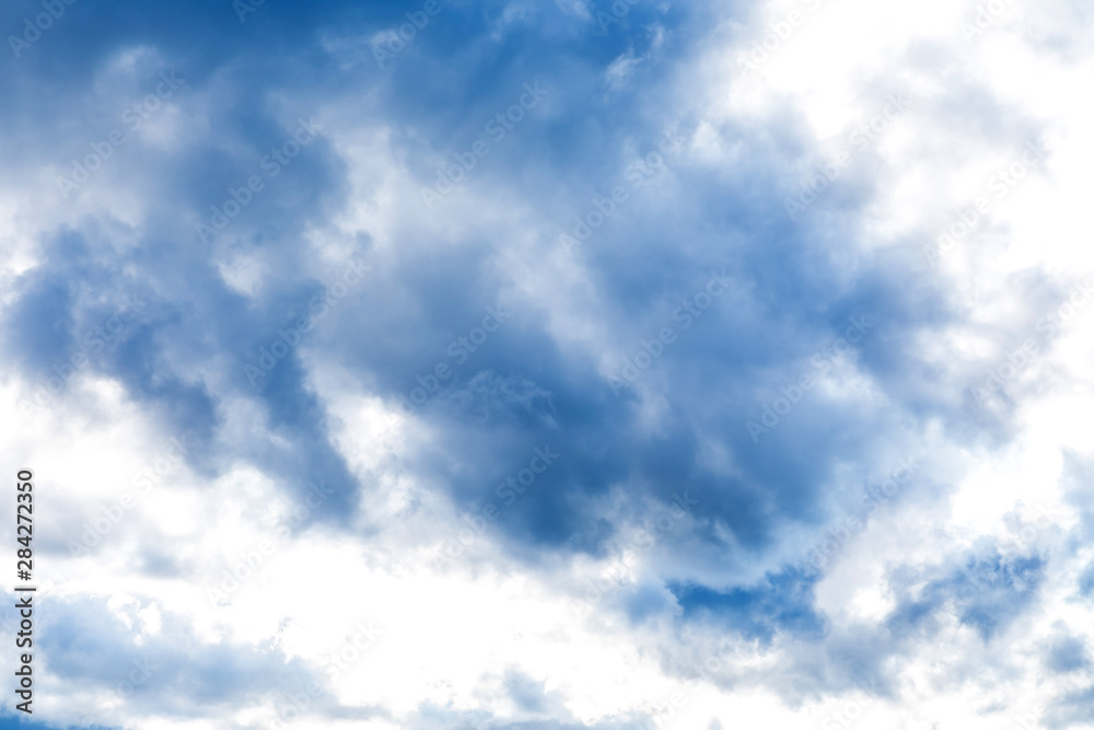The vivid sky or heaven background with white and blue clouds under the sun rays The vivid sky or heaven background with white and blue clouds under the sun rays