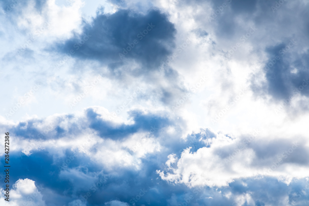 The vivid sky or heaven background with white and blue clouds under the sun rays The vivid sky or heaven background with white and blue clouds under the sun rays