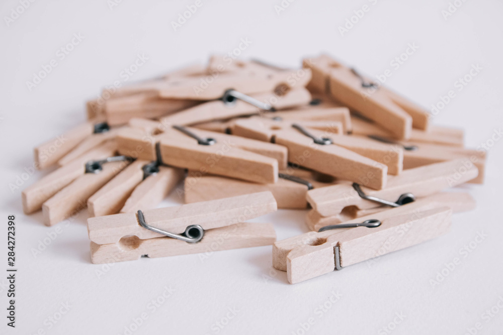 Wooden clothespins scattered on a white background. Copy space Wooden clothespins scattered on a white background. Copy space