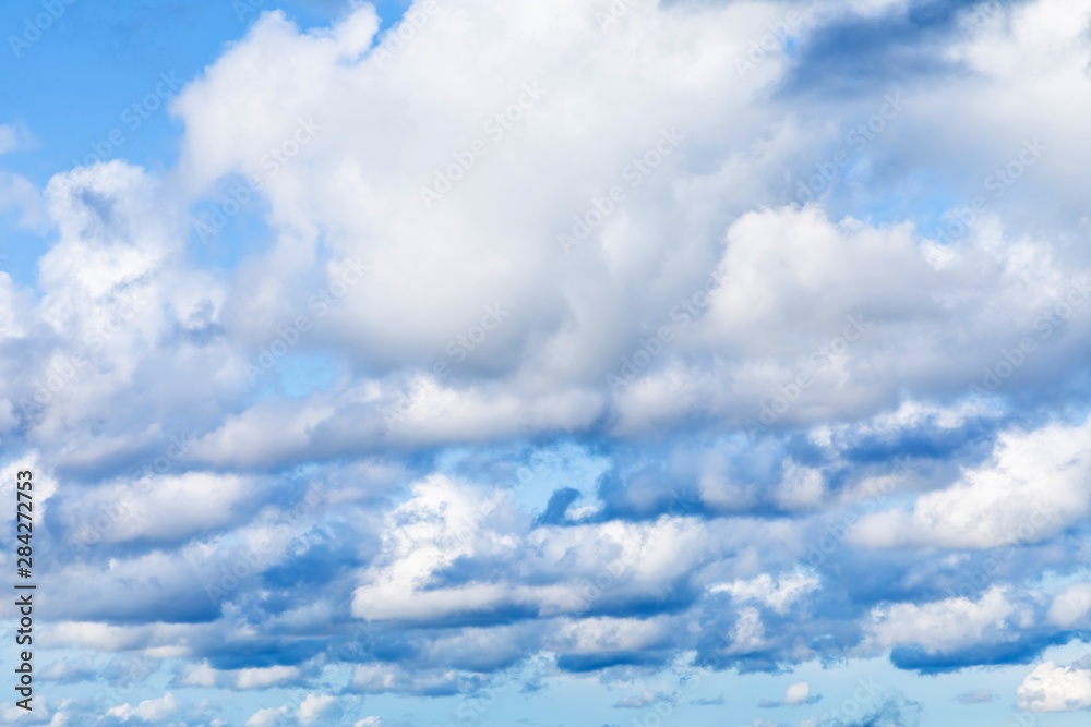The vivid sky or heaven background with white and blue clouds under the sun rays The vivid sky or heaven background with white and blue clouds under the sun rays
