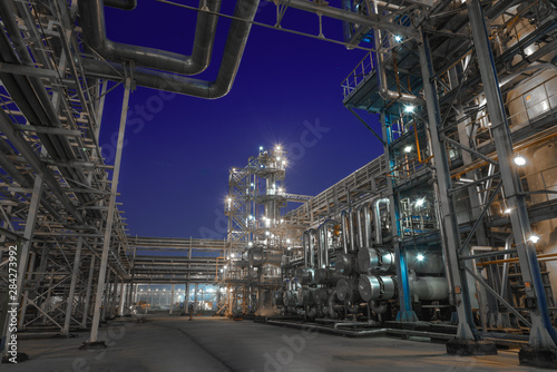 view of metal pipes of industrial plant outdoor at night 