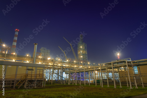 view of metal pipes of industrial plant outdoor at night 