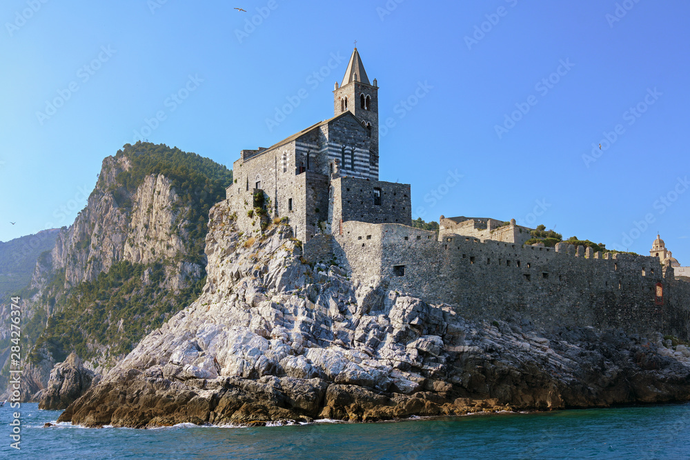 Saint Peter's Church (Chiesa di San Pietro) against the clear blue sky with large copy space, famous landmark in Porto Venere on the Gulf of Poets between La Spezia and Cinque Terre, Liguria, Italy