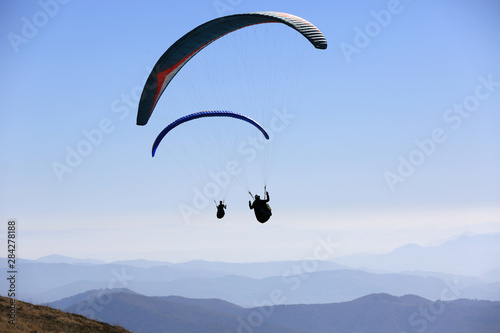 flying paragliders in air
