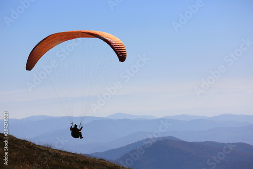flying paraglider in sky