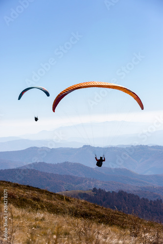 flying paragliders in air