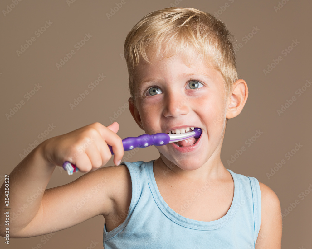 little baby boy with tooth brush,kid boy smiling happiness,dental hygiene and health for children,brown background. little baby boy with tooth brush,kid boy smiling happiness,dental hygiene and health for children,brown background.