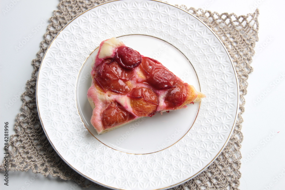 Slice of plum cake on plate with background Slice of plum cake on plate with background