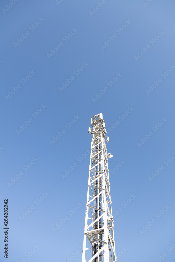 high telecommunication antenna with blue sky background high telecommunication antenna with blue sky background