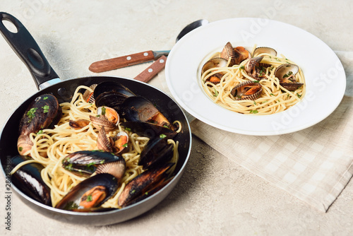 italian delicious pasta with seafood on textured grey background