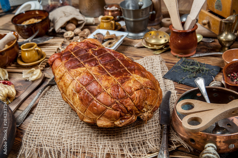 Smoked ham in a grid on a wooden table. (View from a different angle in the portfolio)