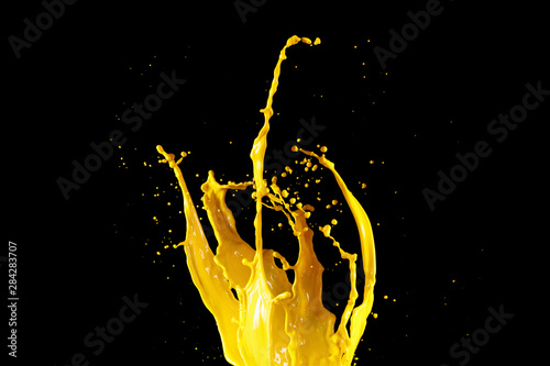 Yellow paint splash isolated on black background