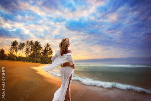 Woman on the beach at sunset in Asia