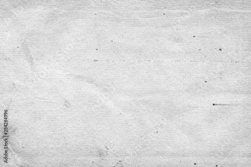 Cardboard white texture close-up. Light old paper background. Grunge concrete wall. Vintage blank wallpaper.