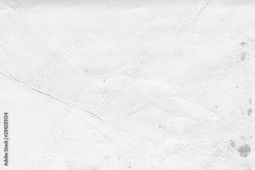 Cardboard white texture close-up. Light old paper background. Grunge concrete wall. Vintage blank wallpaper.