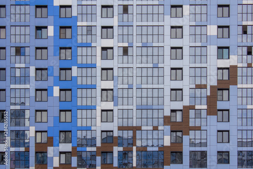facade of a modern glass bright multi-colored multi-storey building with windows