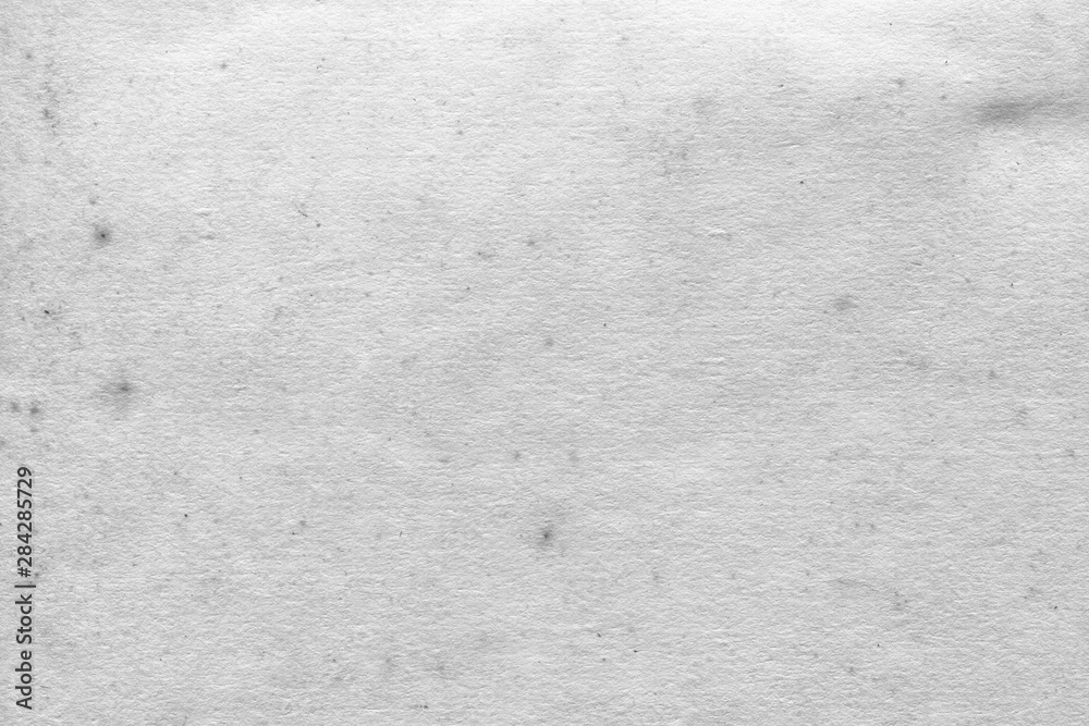 Fototapeta premium Cardboard white texture close-up. Light old paper background. Grunge concrete wall. Vintage blank wallpaper.