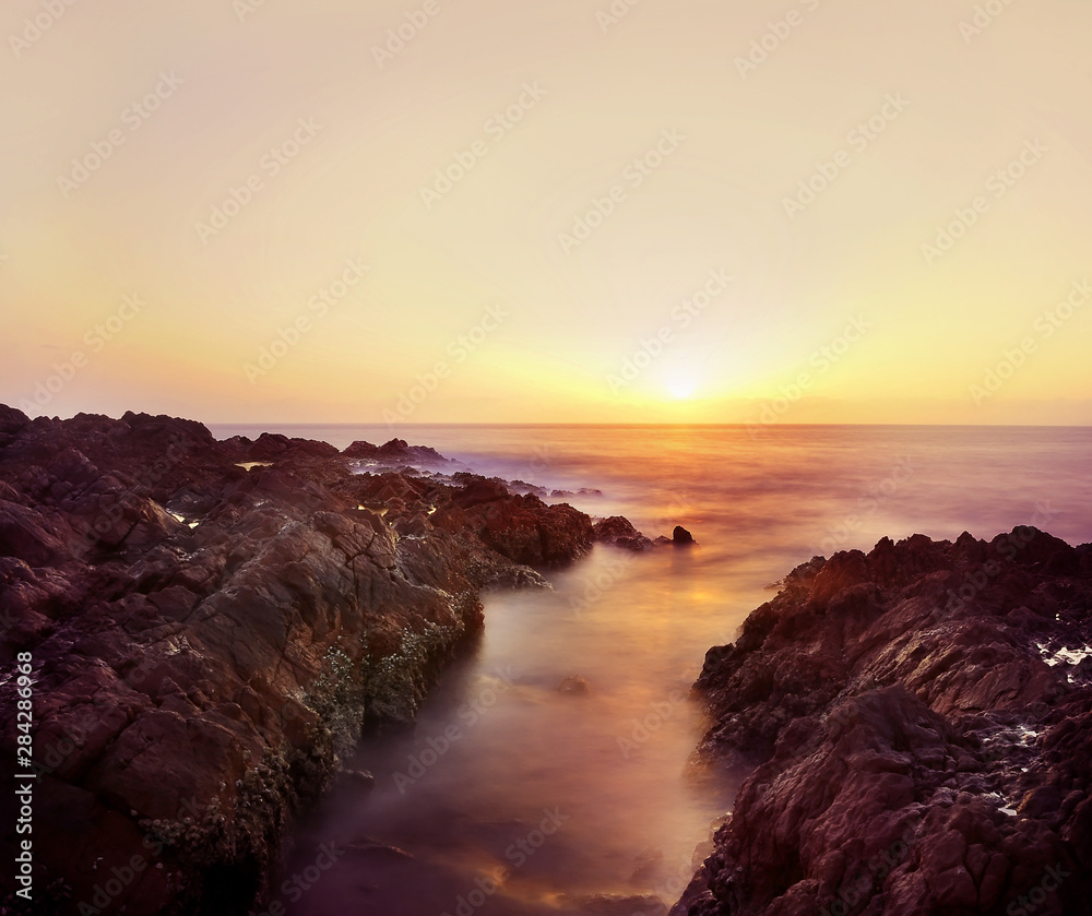 Dawn on the wild coast of the island in the Indian Ocean. long exposure.