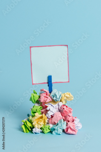 Reminder pile colored crumpled paper clothespin reminder blue background © Artur