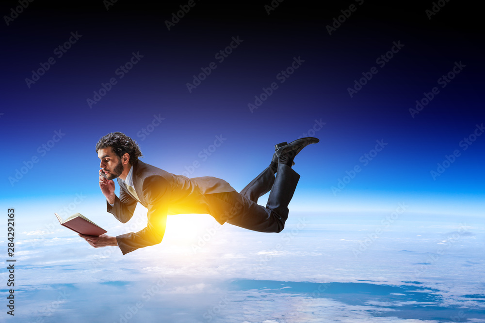 Joyful happe businessman levitating horizontally