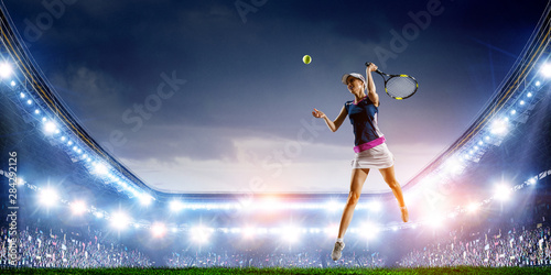 Young woman playing tennis in action